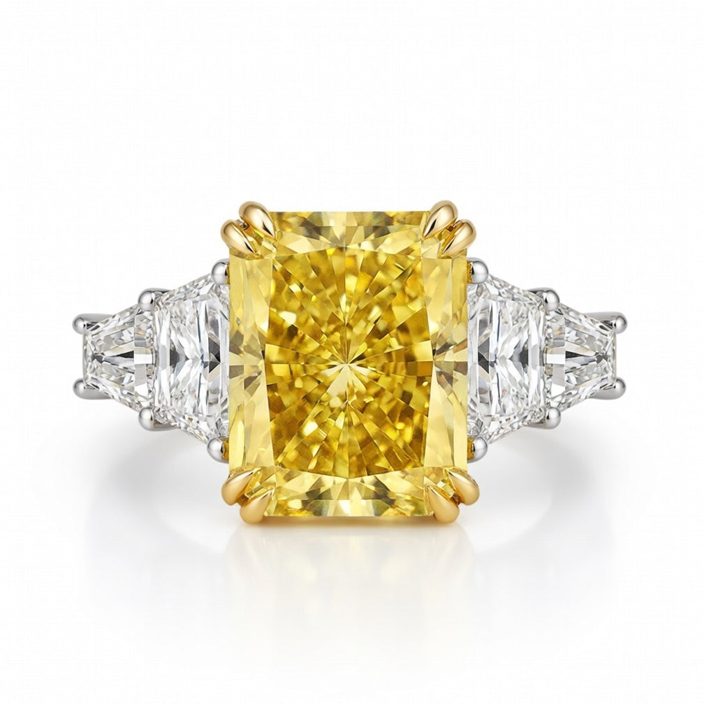Radiant-cut yellow 3.5 carat diamond set in 18k yellow gold, flanked by 1.5 carat diamond side stones in 18k white gold
