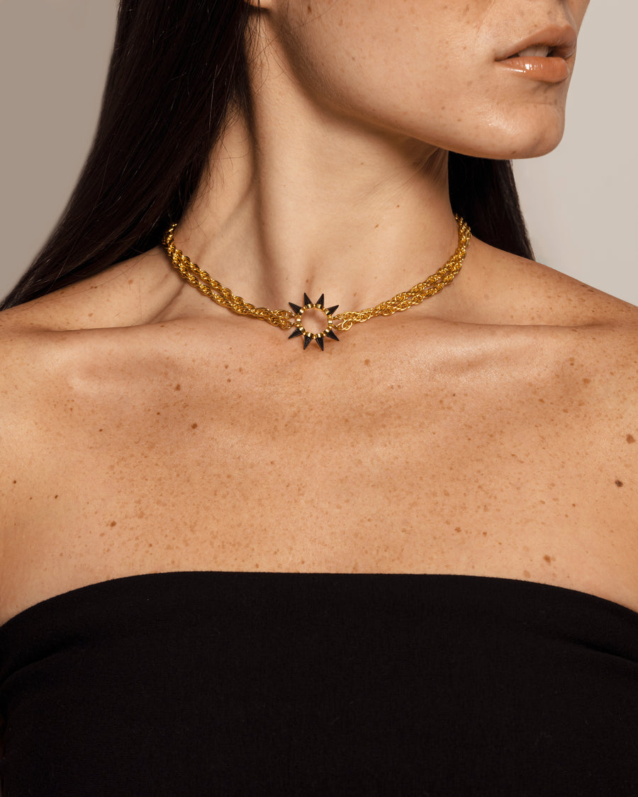 Woman with solid yellow gold choker necklace with edgy spike pendant, plated with Rhodium