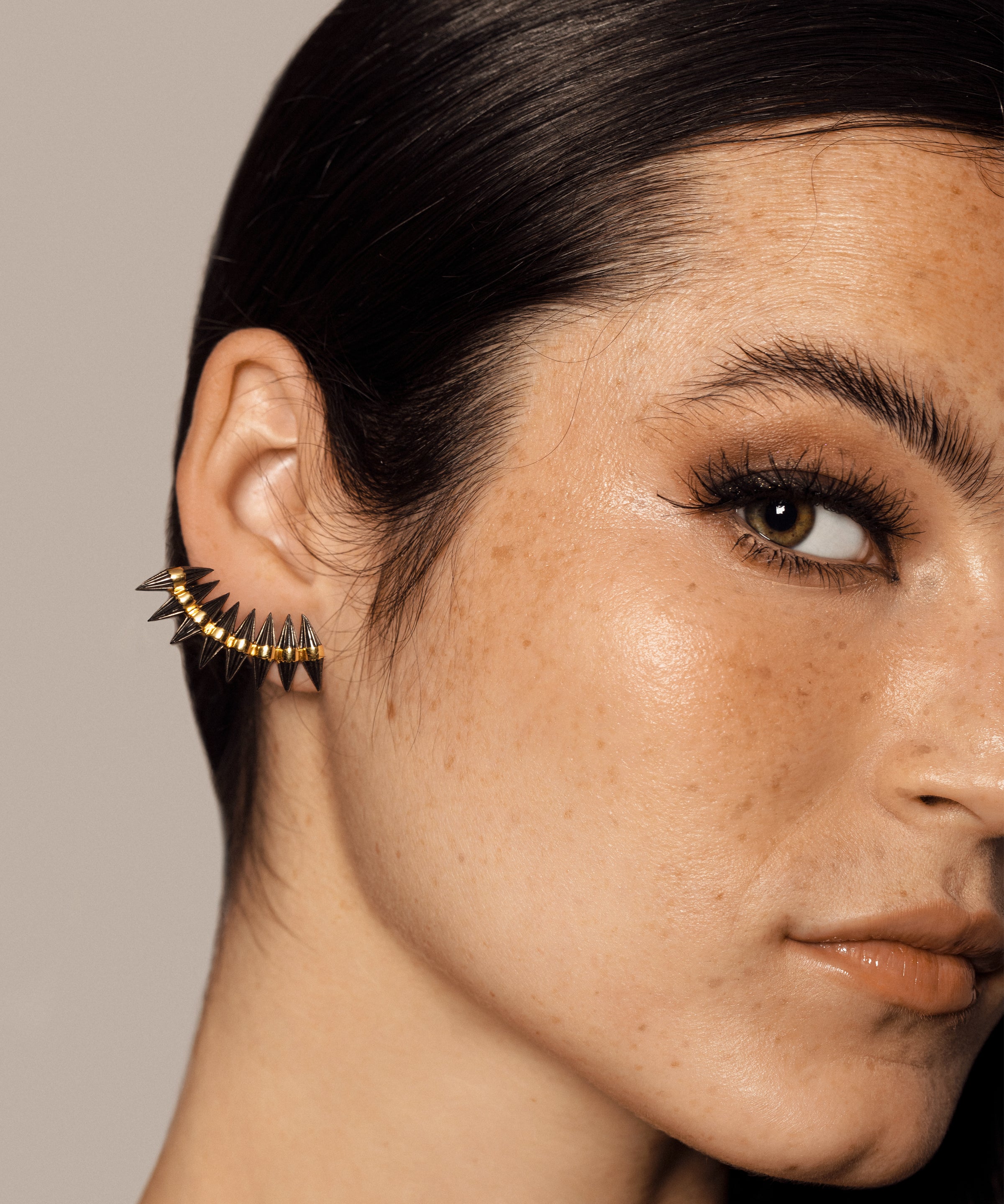 solid gold cuff earring with edgy spikes that are plated Rhodium