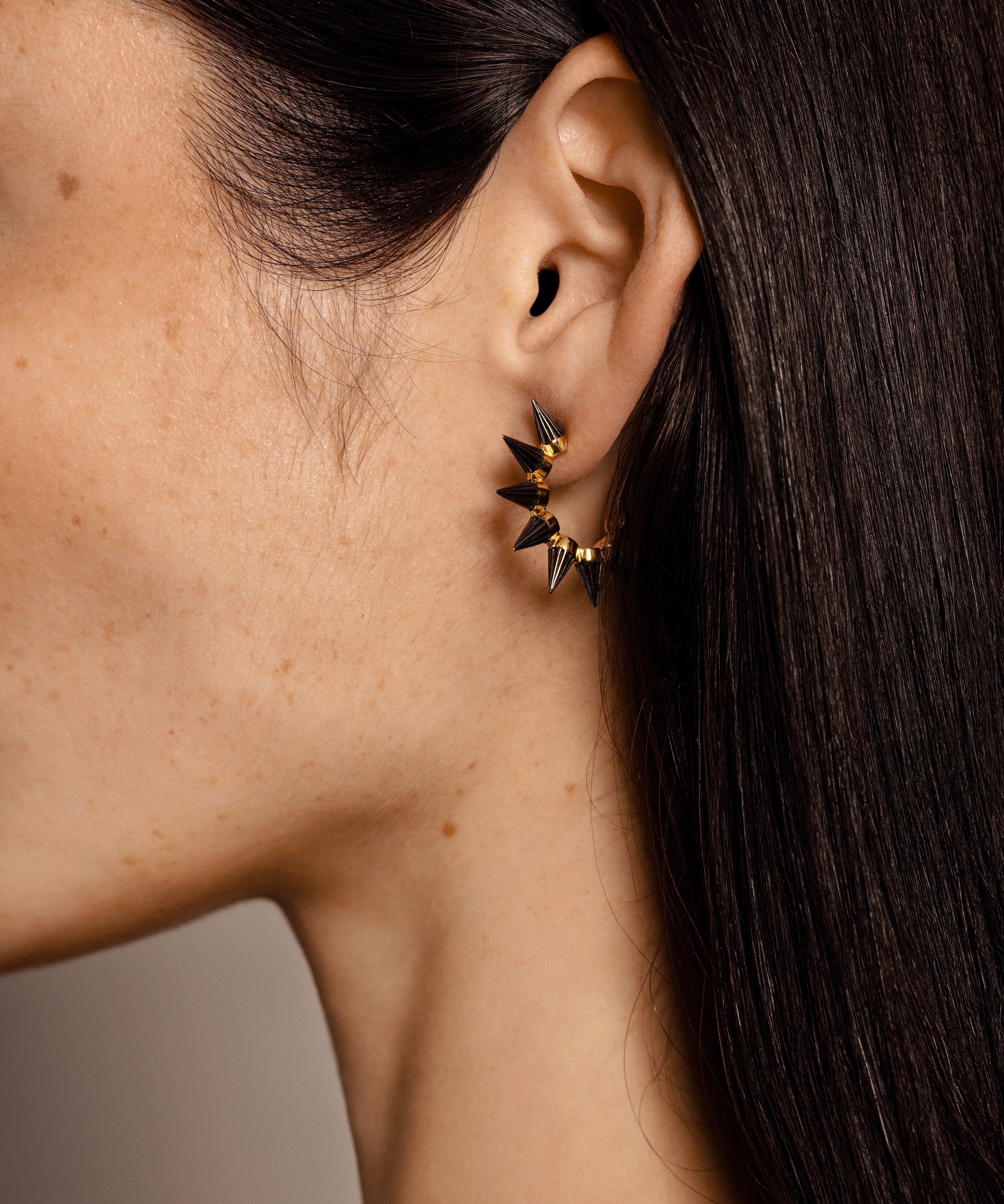 Solid gold hoop earings with edgy spikes, plated with Rhodium.