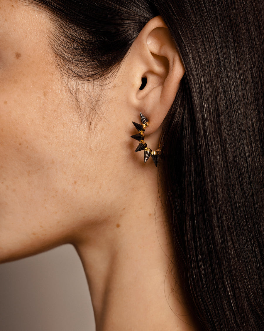 Solid gold hoop earings with edgy spikes, plated with Rhodium.